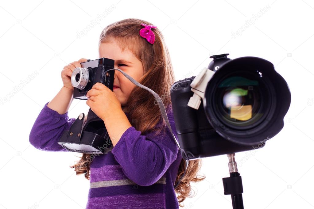 A little girl is taking pictures