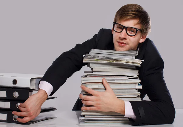 Portrait of handsome man posing on grey background with magazin — Stock Photo, Image