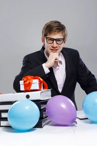 Portrét pohledný muž pózuje na šedém pozadí s balónem — Stock fotografie