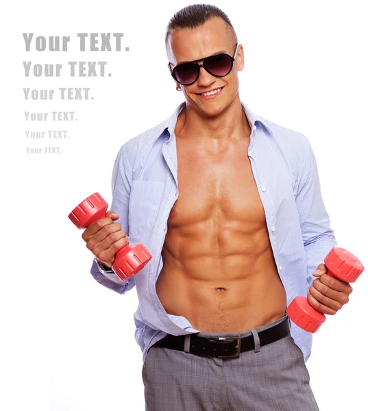 Hot guy is posing in studio with dumbbells — Stock Photo, Image