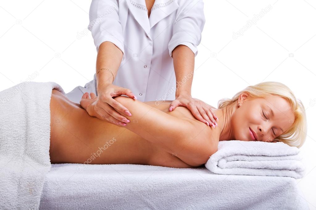 Therapist massages clients shoulder area
