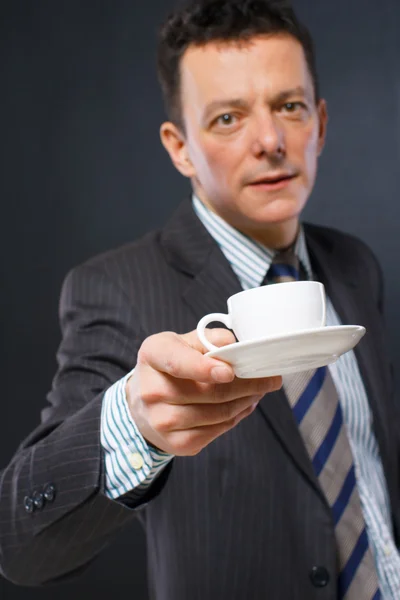 Image of man who is offering a coffee cup — Stock Photo, Image