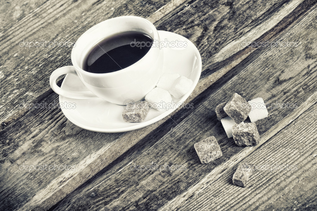Black and white image of coffee cup and sugar