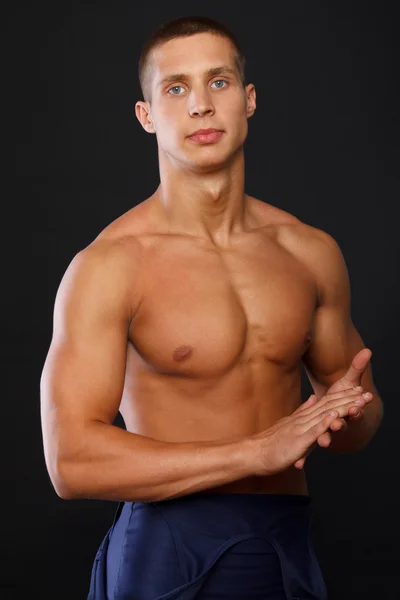 Young attractive athlete in blue shorts — Stock Photo, Image