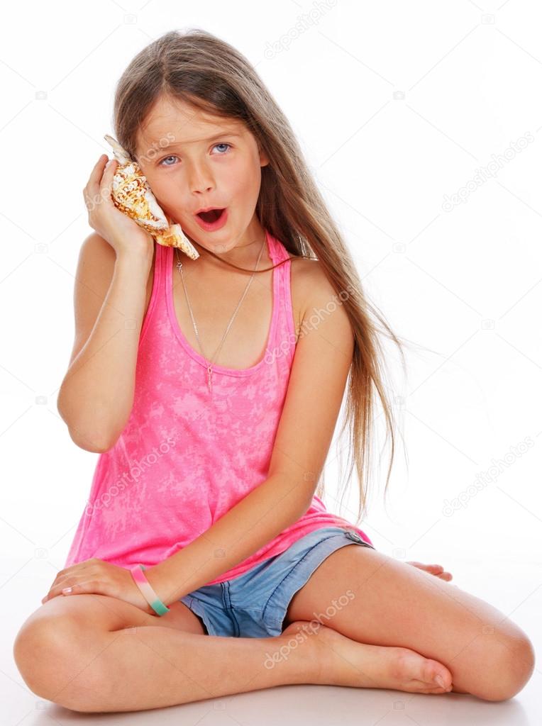 Little girl is fooling around with shell