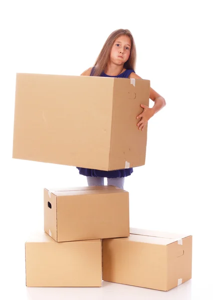 Little girl is holding heavy box — Stock Photo, Image