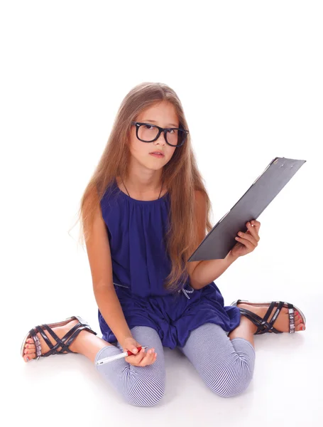 Little sitting girl confused because of questions on the blank Stock Picture