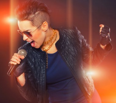 Hot rocker is singing in microphone clipart