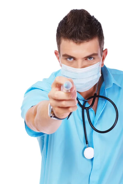 Young doctor with a stylish haircut is pointing with a syringe — Stock Photo, Image