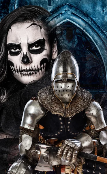 Dark skulled face woman and iron knight — Stock Photo, Image