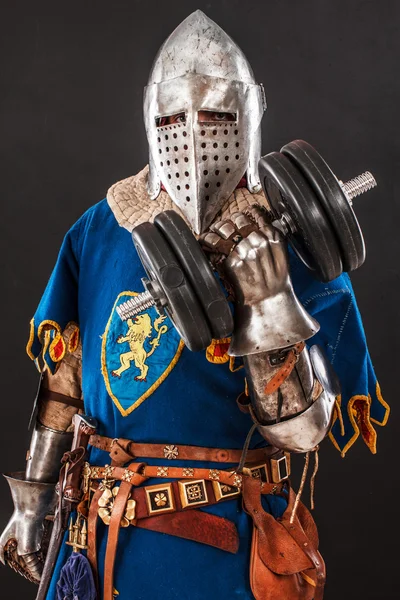 Knight in blue with a dumbbell — Stock Photo, Image