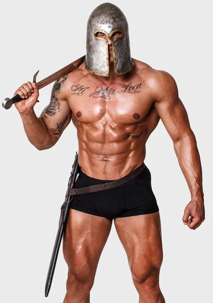 Hot warrior in black pants is holding sword in his shoulder — Stock Photo, Image
