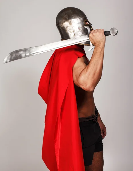 Sideview of shirtless warrior who is holding his sword — Stock Photo, Image