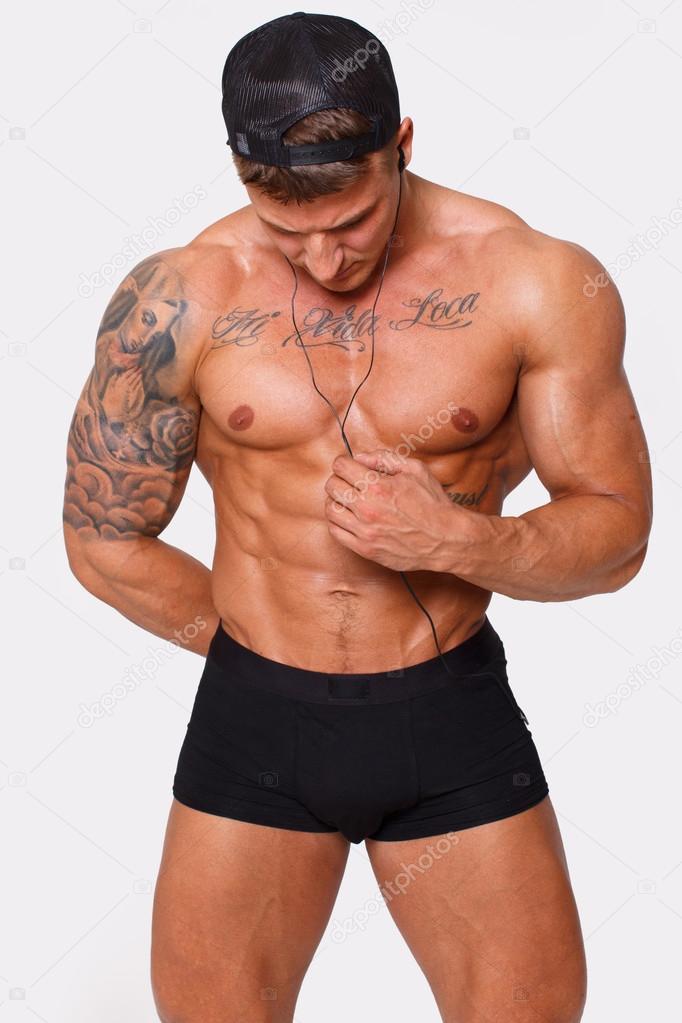 Sexy shirtless man is distracted on his mp3's wire