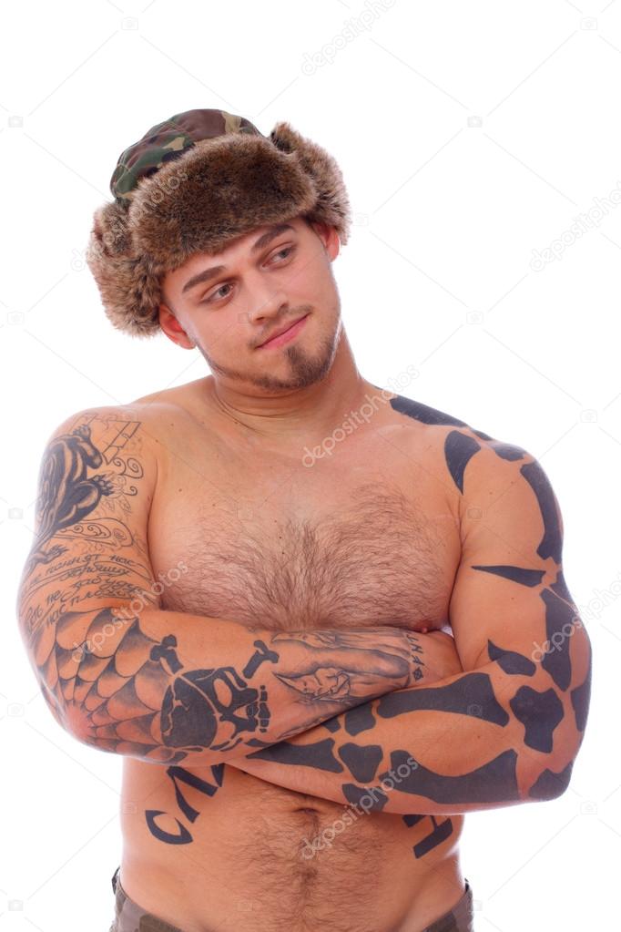 Portrait of shirtless man in russian khaki hat