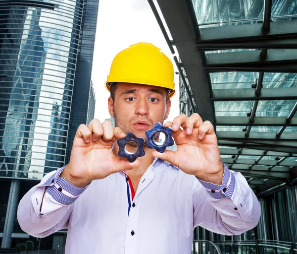 Young constructor is comparing two screws — Stock Photo, Image