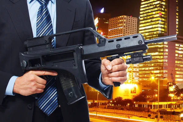 Man is suit is holding a rifle — Stock Photo, Image