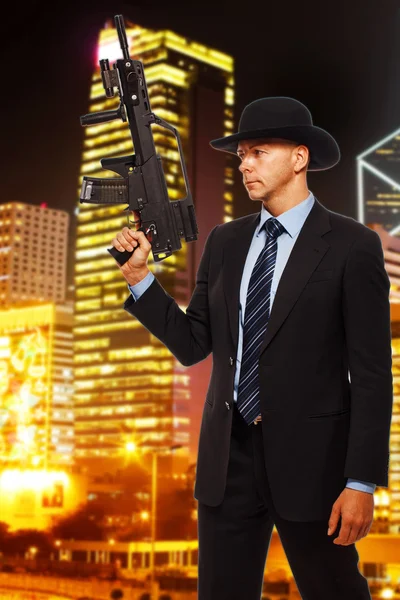 Armed man in a suit — Stock Photo, Image