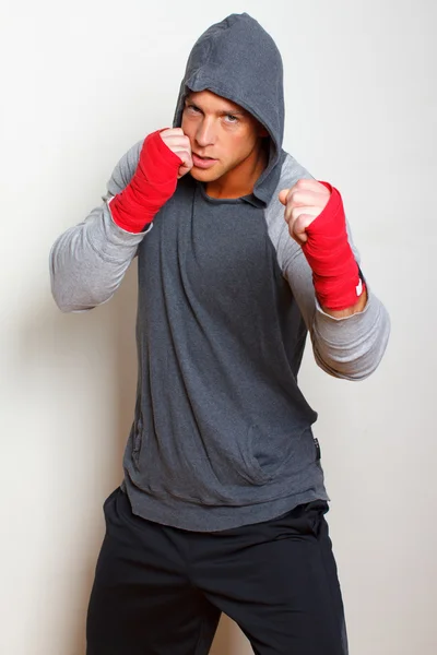 Young boxer is posing on a bright background — Stock Photo, Image
