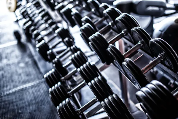 Two rows of iron dumbbells — Stock Photo, Image