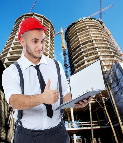 Businessman with a plan on construction — Stock Photo, Image