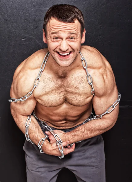 Strong positive man related by chain — Stock Photo, Image