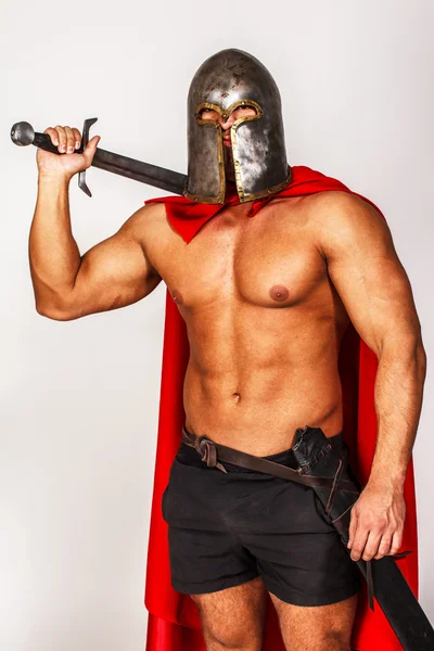 Well looking warrior in red mantle and helmet — Stock Photo, Image