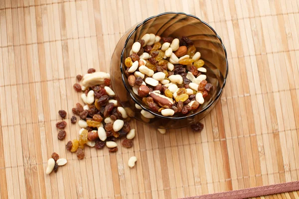 Nuts and raisins in the plate — Stock Photo, Image