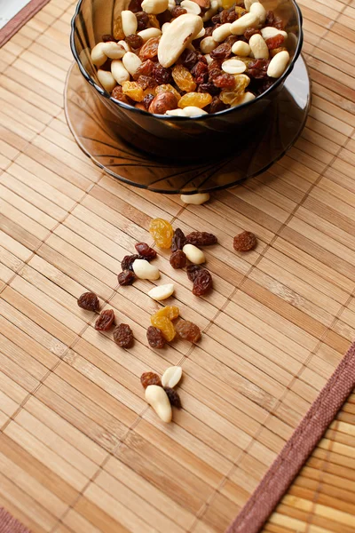 Raisins and nuts in the plate — Stock Photo, Image