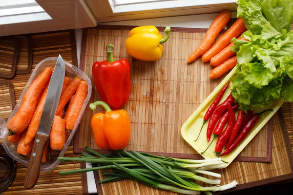 Verduras frescas y cuchillo sobre la mesa — Foto de Stock