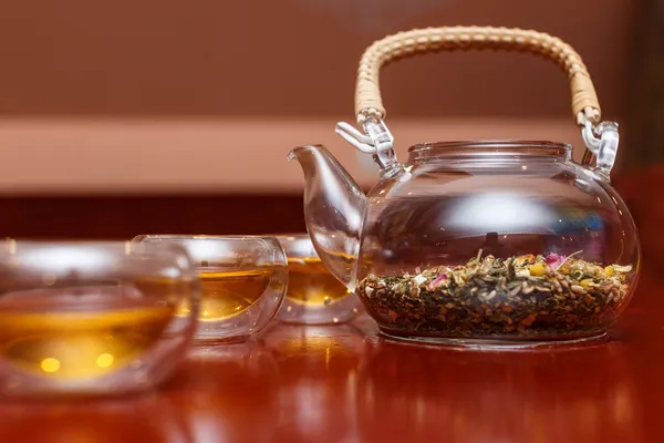 Herbal tea in a transparent teapot — Stock Photo, Image