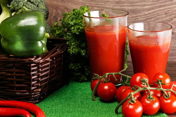 Basket with green veggies and two glasses of juice — Stock Photo, Image