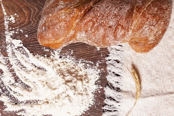 Healthy bread and flour on wood — Stock Photo, Image