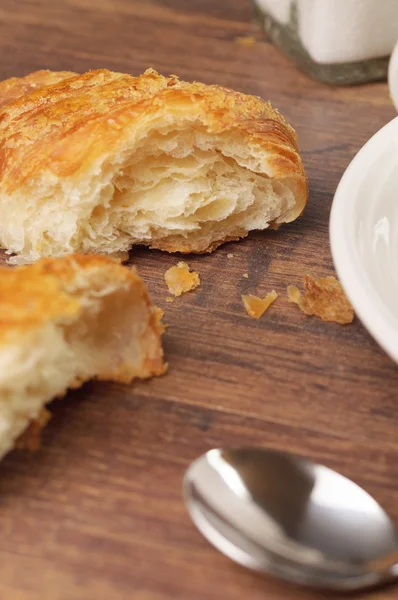Two pieces of a flaky croissant — Stock Photo, Image
