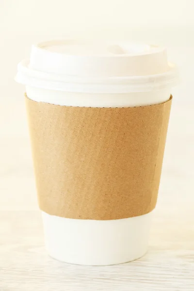 A papercup on a patterned background — Stock Photo, Image