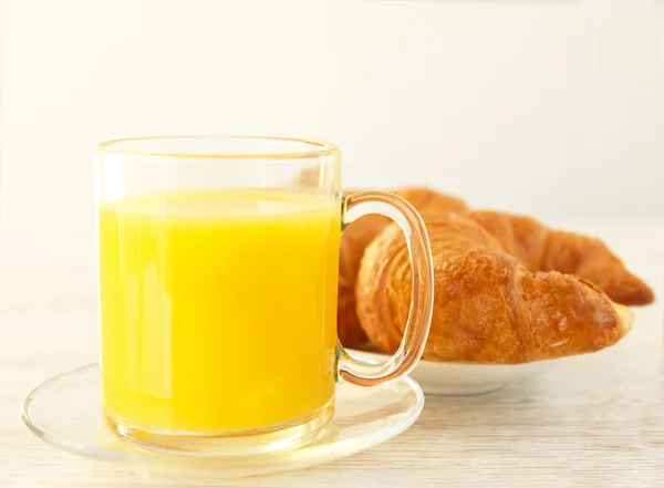 A glass jar of juice and a french bun — Stock Photo, Image