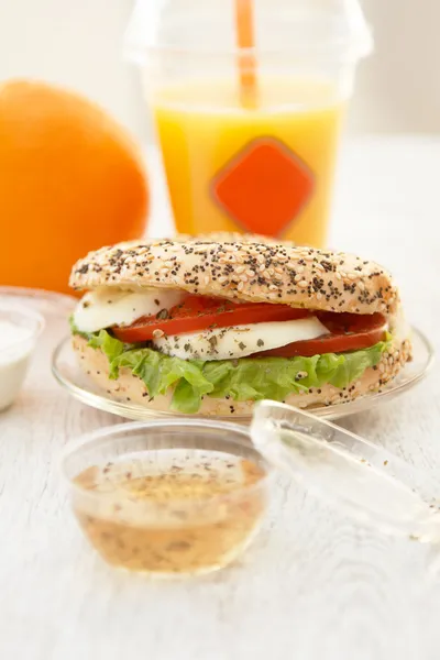 Takeaway poppyseed and sesame mozarella bun — Stock Photo, Image