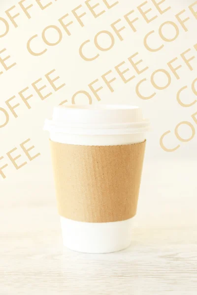 A papercup on a patterned background — Stock Photo, Image