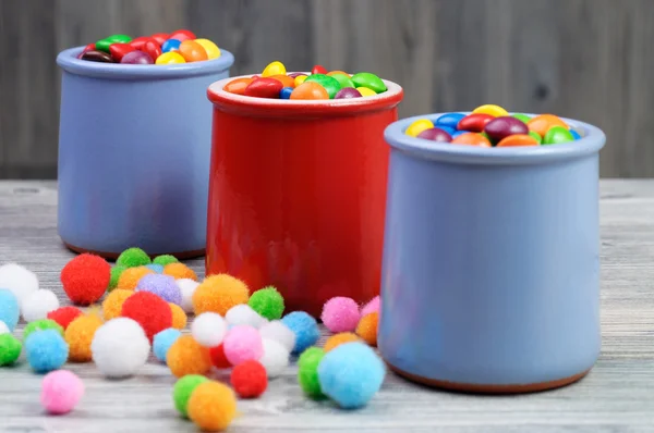 Drei Gläser mit bunten Bonbons und Filzperlen — Stockfoto