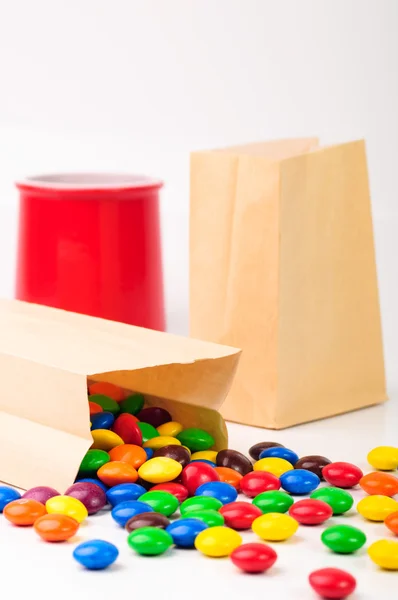 Different color candies in paper bags — Stock Photo, Image