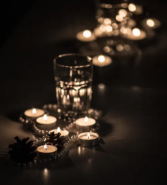 Pearl beads and candles in a romantic setting — Stock Photo, Image