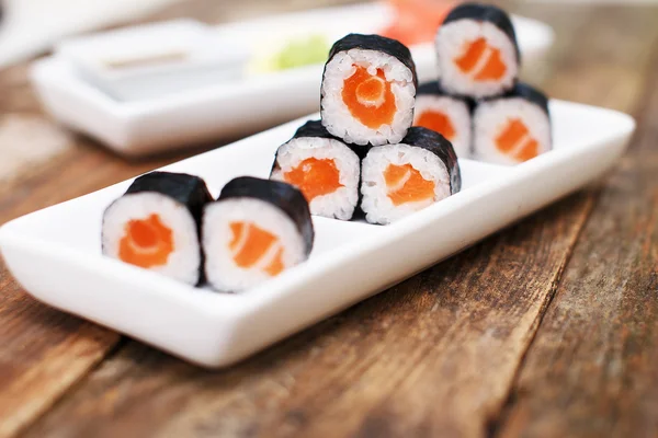 Salmon sushi set on a white plate — Stock Photo, Image