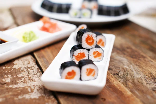 Salmon sushi set on a wooden table — Stock Photo, Image