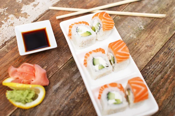 Traditional japanese sushi on a white plate — Stock Photo, Image