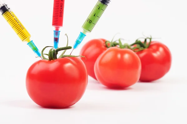 Tres manzanas con jeringas inyectando líquido colorido — Foto de Stock