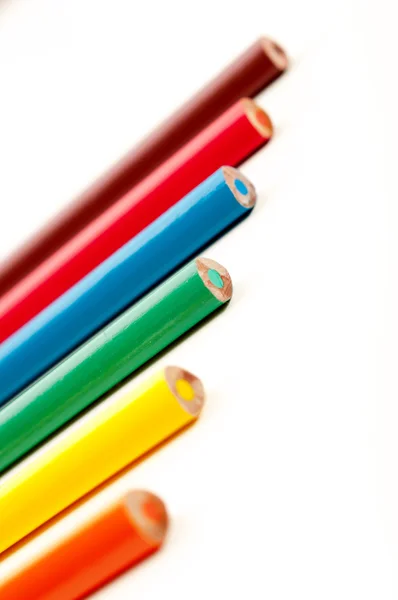 Coloring pencils pointing at candy pattern — Stock Photo, Image