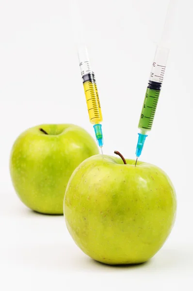 Three apple with syringes injecting colorful liquid — Stock Photo, Image