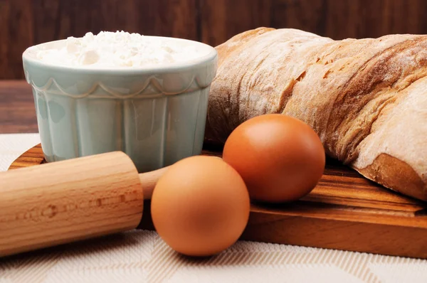 A loaf of crusty bread and a jar of oats — Stock Photo, Image