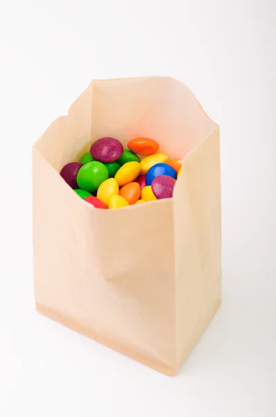 A paperbag full of colorful candies — Stock Photo, Image