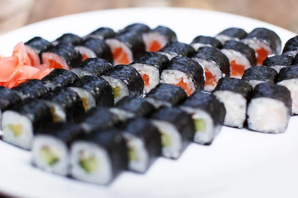 Several sets of different sushi on a white plate — Stock Photo, Image